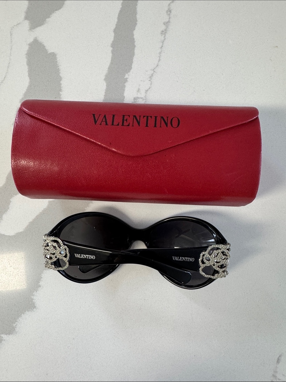 Valentino Black Oval Sunglasses with Crystal Logo Embellishments